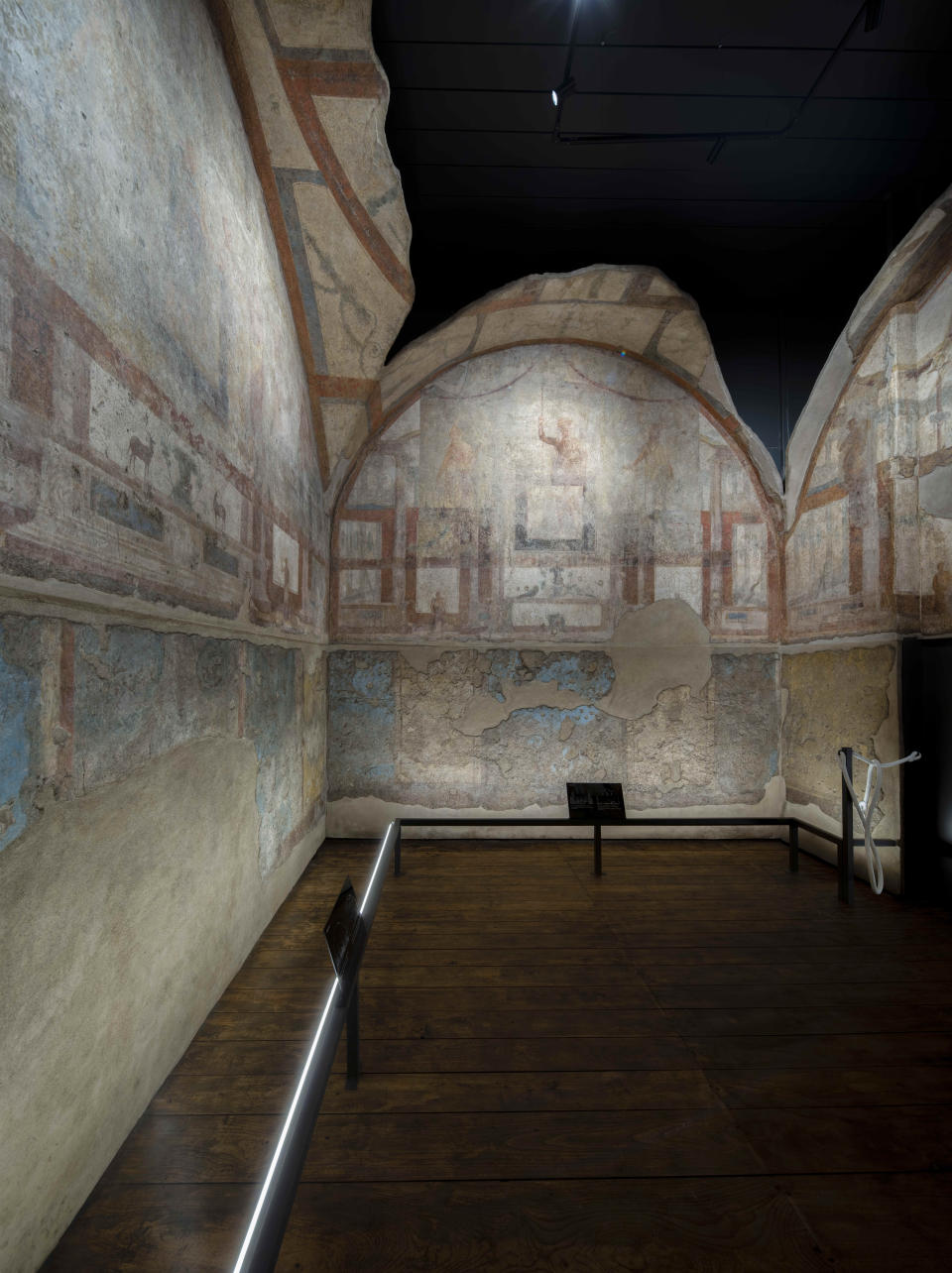The frescoes coming from the sacellum, a small votive chapel, of a two-story home, or "Domus," dating from around 134-138 AD that was partially destroyed to make way for the construction of the Caracalla public baths, which opened in 216 AD, are on display at the Caracalla archaeological park in Rome, Thursday, June 23, 2022. The frescoed ceiling and walls of a domestic temple honoring Greco-Roman and Egyptian religious deities and believed to have belonged to a wealthy merchant family were first discovered in the mid-19th century about 10 meters (yards) underneath the current ground level of the baths, had been briefly exhibited but has been closed to the public for 30 years. (AP Photo/Domenico Stinellis)