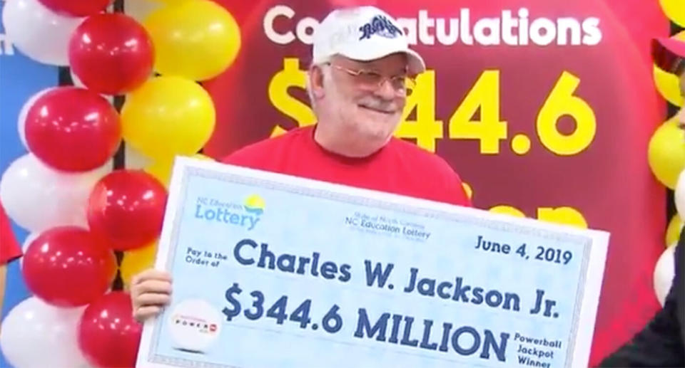 North Carolina lotto winner Charles W. Jackson Jr holds up his winning cheque.