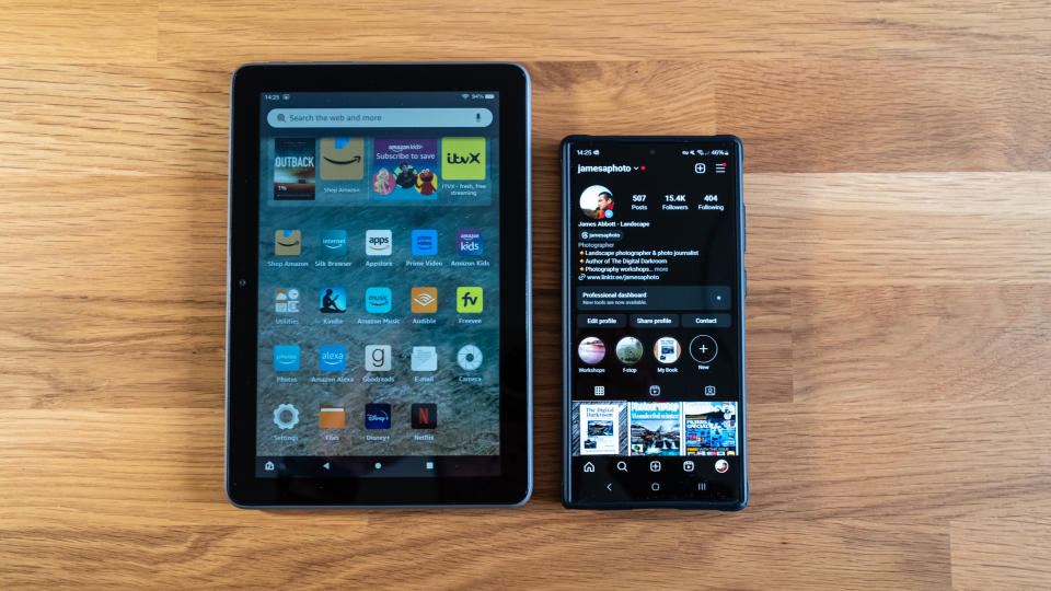 Amazon Fire HD 8 Plus next to a Samsung phone on a wooden surface