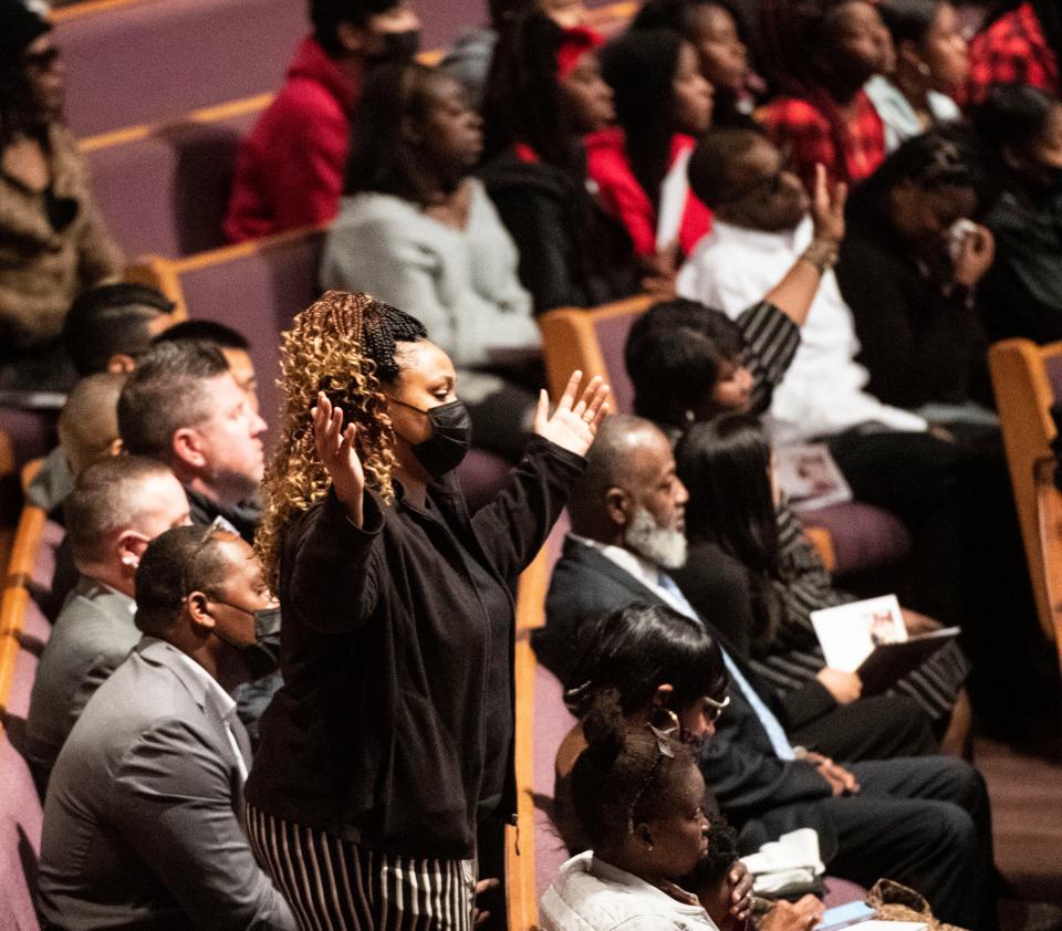 Crowd members lift hands in pray for children who attend Tanglewood Middle School during the funeral service for Jamari Cortez Bonaparte Jackson at Relentless Church in Greenville, Saturday, April 9, 2022.