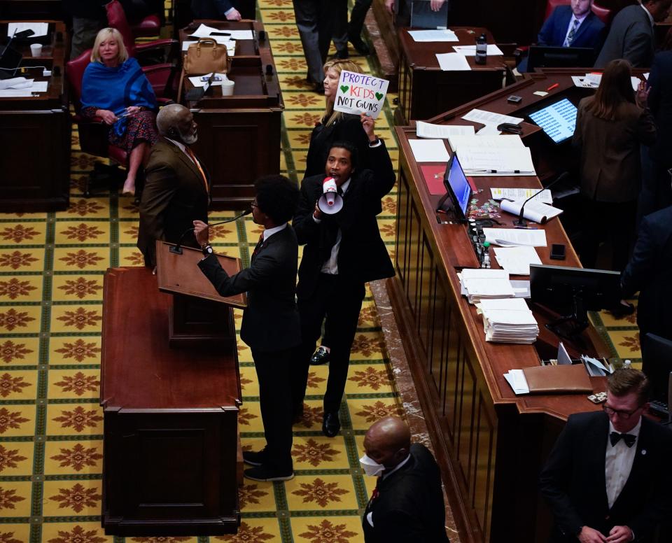 State Representative Justin Jones of Nashville speaks into a megaphone during a rally against gun violence on Thursday, March 30, 2023, in Nashville, Tenn. The action came in the wake of the Covenant School shooting that killed six people earlier in the week.