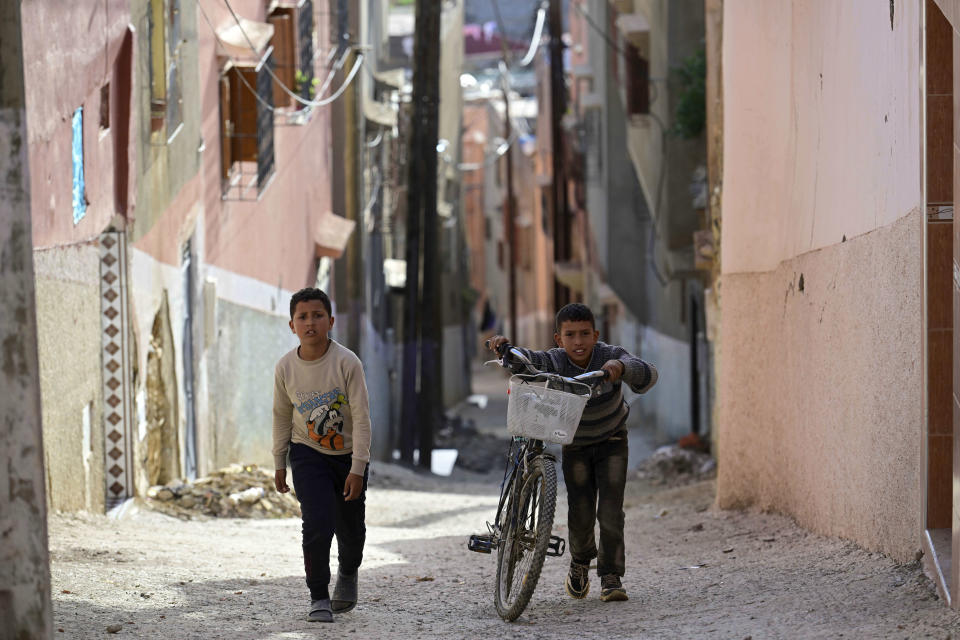 Boys who have been displaced by the earthquake walk up a hill in their hometown of Amizmiz, near Marrakech, Thursday, April 4, 2024. (AP Photo)