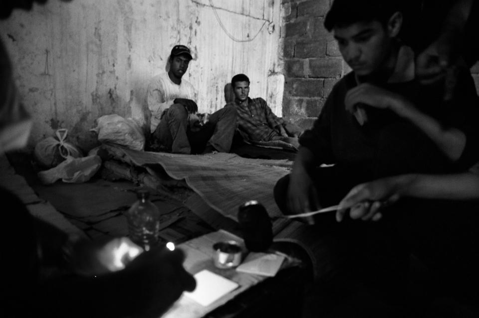 A group of Algerian kids cooking inside the abandoned factory where they live in the Spanish enclave of Ceuta 2005. (Photo: José Colón/MeMo for Yahoo News)