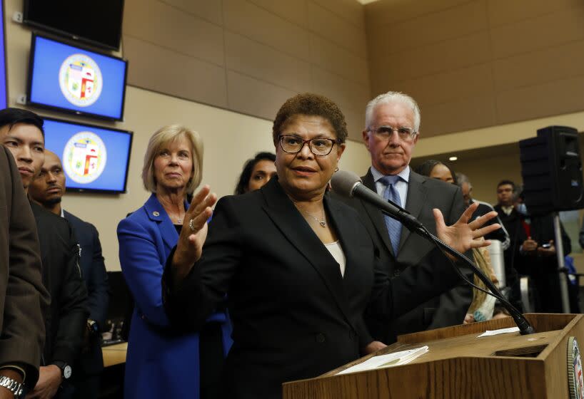 Los Angeles, California -Dec. 12, 2022-On Dec. 12, 2022, Mayor Karen Bass takes questions from the media after declaring a state of emergency against homelessness at the city's Emergency Operations Center, which will allow her to take aggressive executive actions to confront the homelessness crisis in Los Angeles. The declaration will recognize the severity of Los Angeles' crisis and break new ground to maximize the ability to urgently move people inside. From left are Supervisor Janice Hahn, Mayor Karen Bass, and Councilmember District 2 Paul Kredorian. (Carolyn Cole / Los Angeles Times)