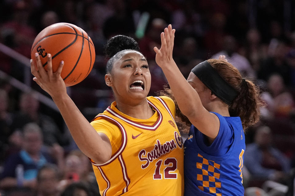 Southern California guard JuJu Watkins, left, shoots as UC Riverside guard Makayla Jackson defends during the first half of an NCAA college basketball game Sunday, Dec. 10, 2023, in Los Angeles. (AP Photo/Mark J. Terrill)