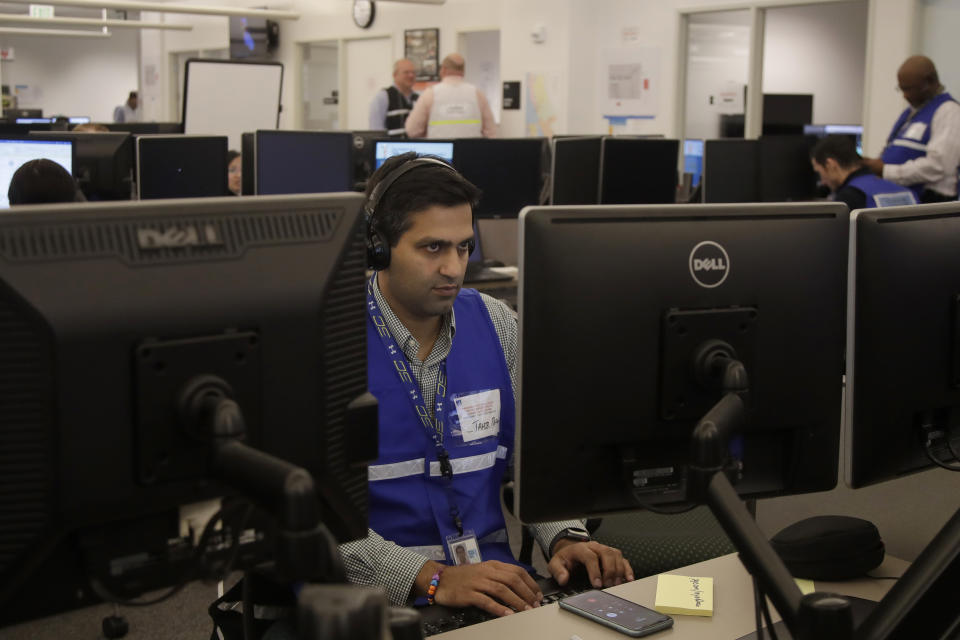 Pacific Gas & Electric employees work in the PG&E Emergency Operations Center in San Francisco, Thursday, Oct. 10, 2019. More than 1.5 million people in Northern California were in the dark Thursday, most for a second day, after the state's biggest utility shut off electricity to many areas to prevent its equipment from sparking wildfires as strong winds sweep through. (AP Photo/Jeff Chiu)