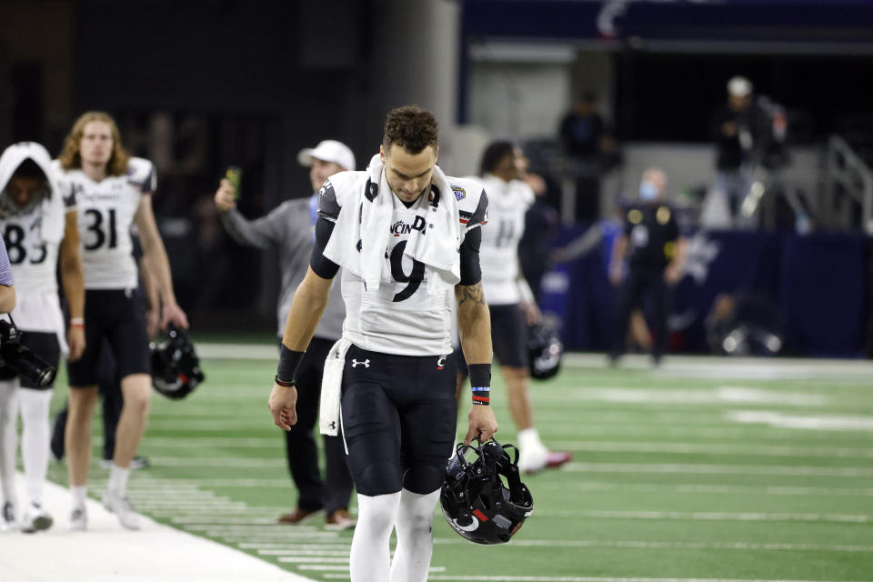 Cincinnati quarterback Desmond Ridder (9) leaves the field after the Cotton Bowl NCAA College Football Playoff semifinal game against Alabama, Friday, Dec. 31, 2021, in Arlington, Texas. Alabama won 27-6. (AP Photo/Michael Ainsworth)