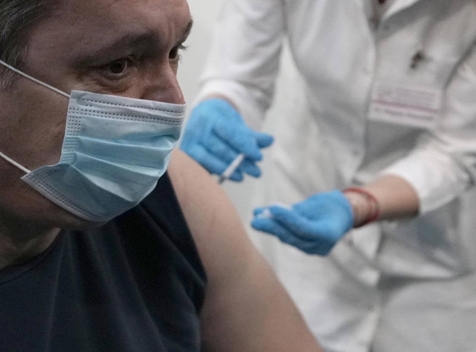 FILE - A medical worker administers a third dose of COVID-19 vaccine to Serbian President Aleksandar Vucic at Belgrade Fair makeshift vaccination center, Serbia, Sunday, Nov. 7, 2021. Throughout the Central and Eastern Europe, where vaccination rates are much lower than in the rest of the continent, the surprisingly tough wave has ripped through mercilessly during the past two months, hitting record numbers of infections and taking thousands of lives. Amid the surge, the former Communist nations that once carried out nationwide mandatory inoculations without hesitation, and which were quick to impose tough lockdowns at the start of the pandemic, let the virus rage unimpeded for weeks before taking action. (AP Photo/Darko Vojinovic, File)