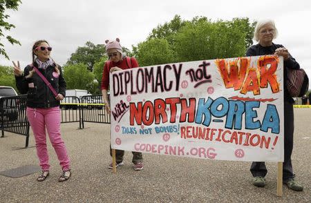 Activists from "the Popular Resistance" and "people opposed to war with North Korea" hold a protest in front of the White House as U.S. senators arrive to receive a closed briefing about North Korea, at the White House in Washington, U.S, April 26, 2017. REUTERS/Kevin Lamarque