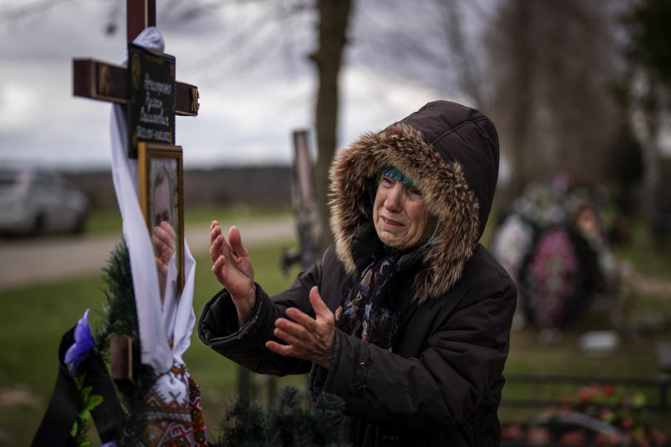 FILE - Valentyna Nechyporenko, 77, mourns at the grave of her 47-year-old son Ruslan, during his funeral at the cemetery in Bucha, on the outskirts of Kyiv, April 18, 2022. Ruslan was killed by Russian army on March 17 while delivering humanitarian aid to his neighbours in the streets of Bucha. Bucha had been occupied by Russian forces for about a month, taken as they swept toward Kyiv at the start of the invasion of Ukraine that began in late February 2022. When they withdrew, they left behind scenes of horror. (AP Photo/Emilio Morenatti, File)
