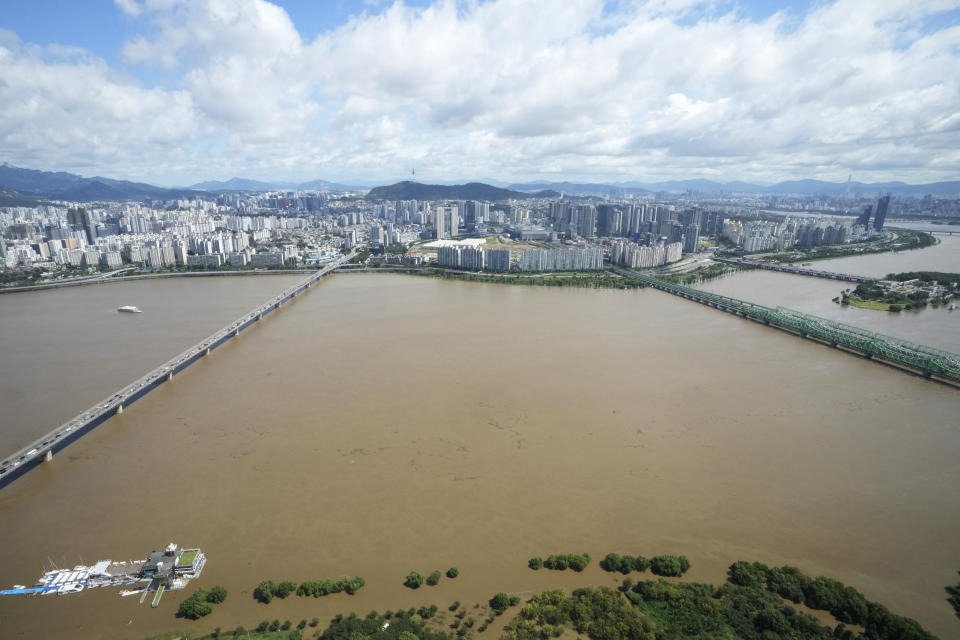 The Han River, swollen with floodwater, flows under bridges in Seoul, South Korea, Tuesday, Sept. 6, 2022. The most powerful typhoon to hit South Korea in years battered its southern region Tuesday, dumping a meter (3 feet) of rain, destroying roads and felling power lines, leaving 66,000 homes without electricity as thousands of people fled to safer ground. (AP Photo/Ahn Young-joon)