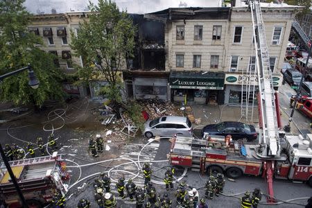 A firefighter respond to an apparent gas explosion and fire in the Brooklyn borough of New York, October 3, 2015. REUTERS/Stephanie Keith