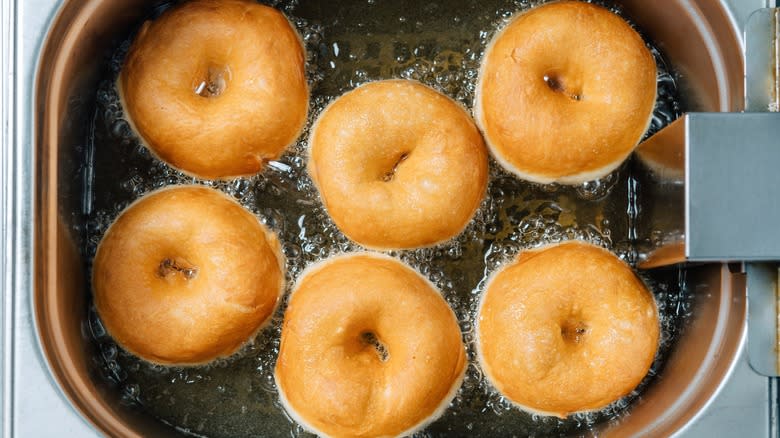 six donuts frying in oil