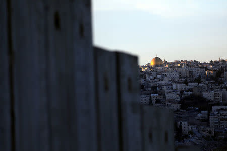 The Dome of the Rock and Jerusalem's Old City can be seen over the Israeli barrier from the Palestinian town of Abu Dis in the West Bank east of Jerusalem December 4, 2017. REUTERS/Ammar Awad