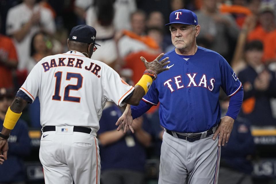 Houston Astros manager Dusty Baker shakes hands with Texas Rangers manager Bruce Bochy before Game 1 of the baseball AL Championship Series Sunday, Oct. 15, 2023, in Houston. (AP Photo/David J. Phillip)