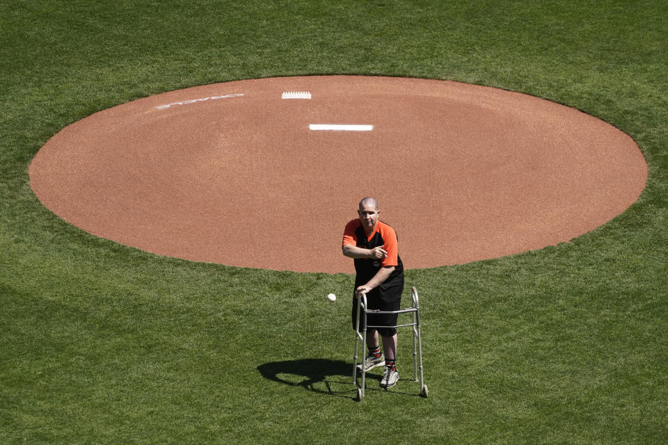 Bryan Stow throws out the ceremonial first pitch before an opening day baseball game between the San Francisco Giants and the Colorado Rockies, Friday, April 9, 2021, in San Francisco. Ten years ago Stow was attacked at Dodger Stadium. (AP Photo/Eric Risberg)