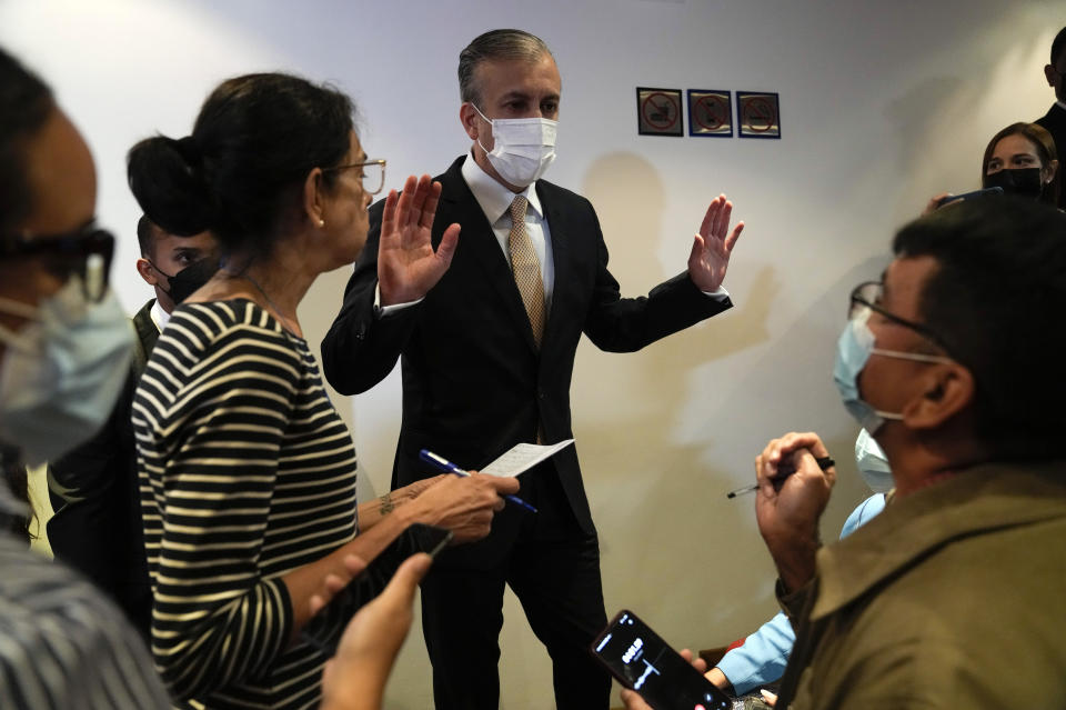 Minister of People's Power of Petroleum of Venezuela Tareck El Aissami, center, speaks to journalist at the end of a press conference at the Public Ministry, in Caracas, Venezuela, Tuesday, Aug. 30, 2022. El Aissami announced his government is seeking an international arrest warrant for former Oil Minister Rafael Ramirez who resides in Europe. (AP Photo/Ariana Cubillos)