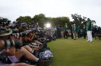 Jordan Spieth of the U.S. has his picture taken wearing the Green Jacket after winning the Masters golf tournament at the Augusta National Golf Course in Augusta, Georgia April 12, 2015. REUTERS/Mark Blinch