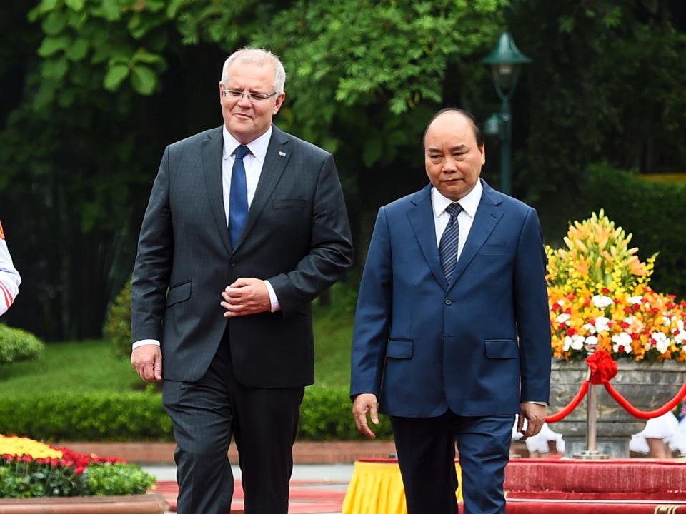 Australia's Prime Minister Scott Morrison (L) inspects a guard of honour with his Vietnamese counterpart Nguyen Xuan Phuc during a welcoming ceremony at the Presidential Palace in Hanoi on August 23, 2019.