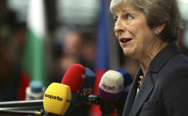 British Prime Minister Theresa May speaks with the media as she arrives for an EU summit in Brussels, Wednesday, Oct. 17, 2018. European Union leaders are converging on Brussels for what had been billed as a "moment of truth" Brexit summit but which now holds little promise for a breakthrough. (AP Photo/Francisco Seco)