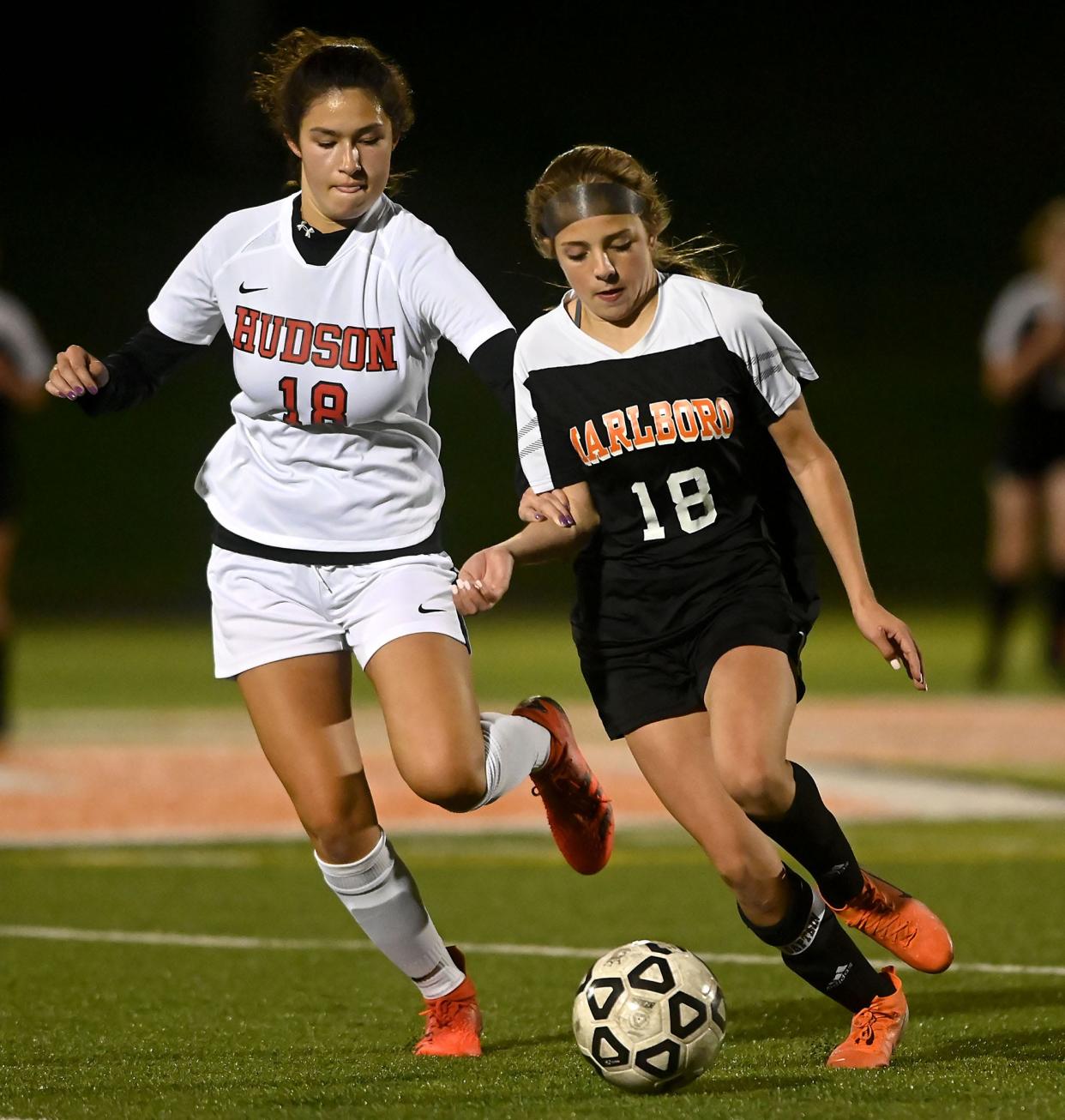 Marlborough's Ava VanBuskirk, right, maneuvers towards the Hudson net as Hudson's Katherine Haufe (18) pursues during the second half at Whitcomb Middle School in Marlborough, Sept. 30, 2021.  