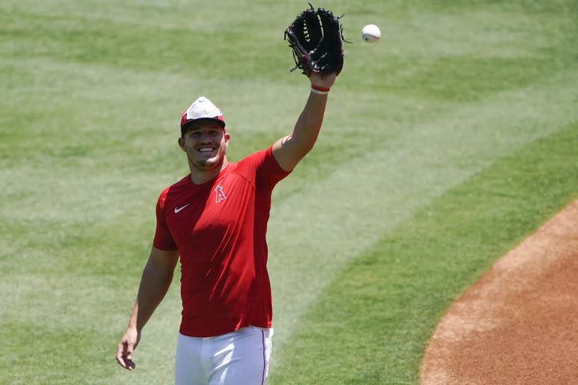 Los Angeles Angels center fielder Mike Trout catches a ball during baseball practice at Angel Stadium on Tuesday, July 7, 2020, in Anaheim, Calif. (AP Photo/Ashley Landis)