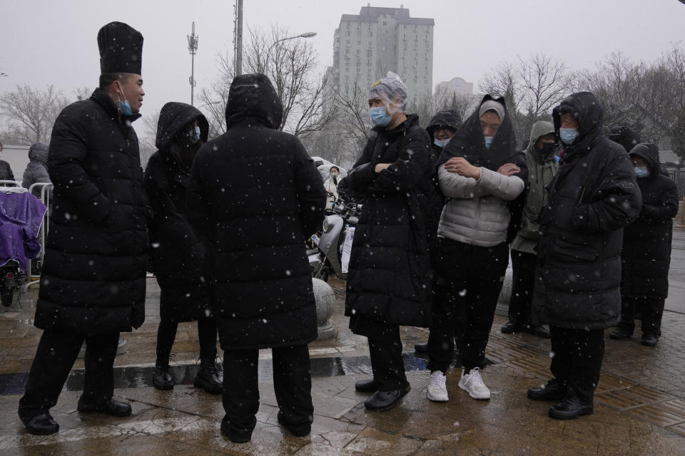 Workers line up for COVID-19 test as it snows on Thursday, March 17, 2022, in Beijing. A fast-spreading variant known as "stealth omicron" is testing China's zero-tolerance strategy, which had kept the virus at bay since the deadly initial outbreak in the city of Wuhan in early 2020. (AP Photo/Ng Han Guan)