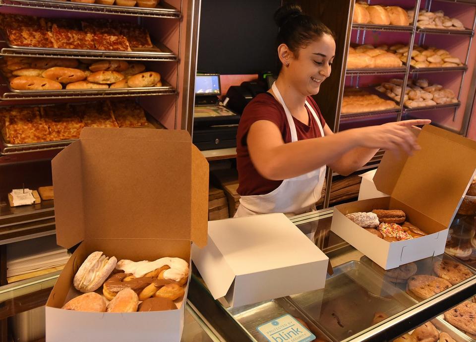 Dina Cabana boxes a large order of doughnuts for a customer at Continent Bakery, Thursday, January 31, 2019, in Swansea, Massachusetts. [Herald News Photo | Jack Foley]