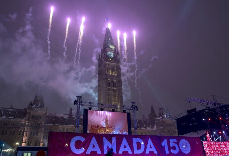 Fireworks light up the sky behind the Peace Tower during a New Year's Eve celebration on Parliament Hill, Saturday, Dec. 31, 2016 in Ottawa. Canada celebrates its 150th anniversary of Confederation in 2017. Photo from The Canadian Press