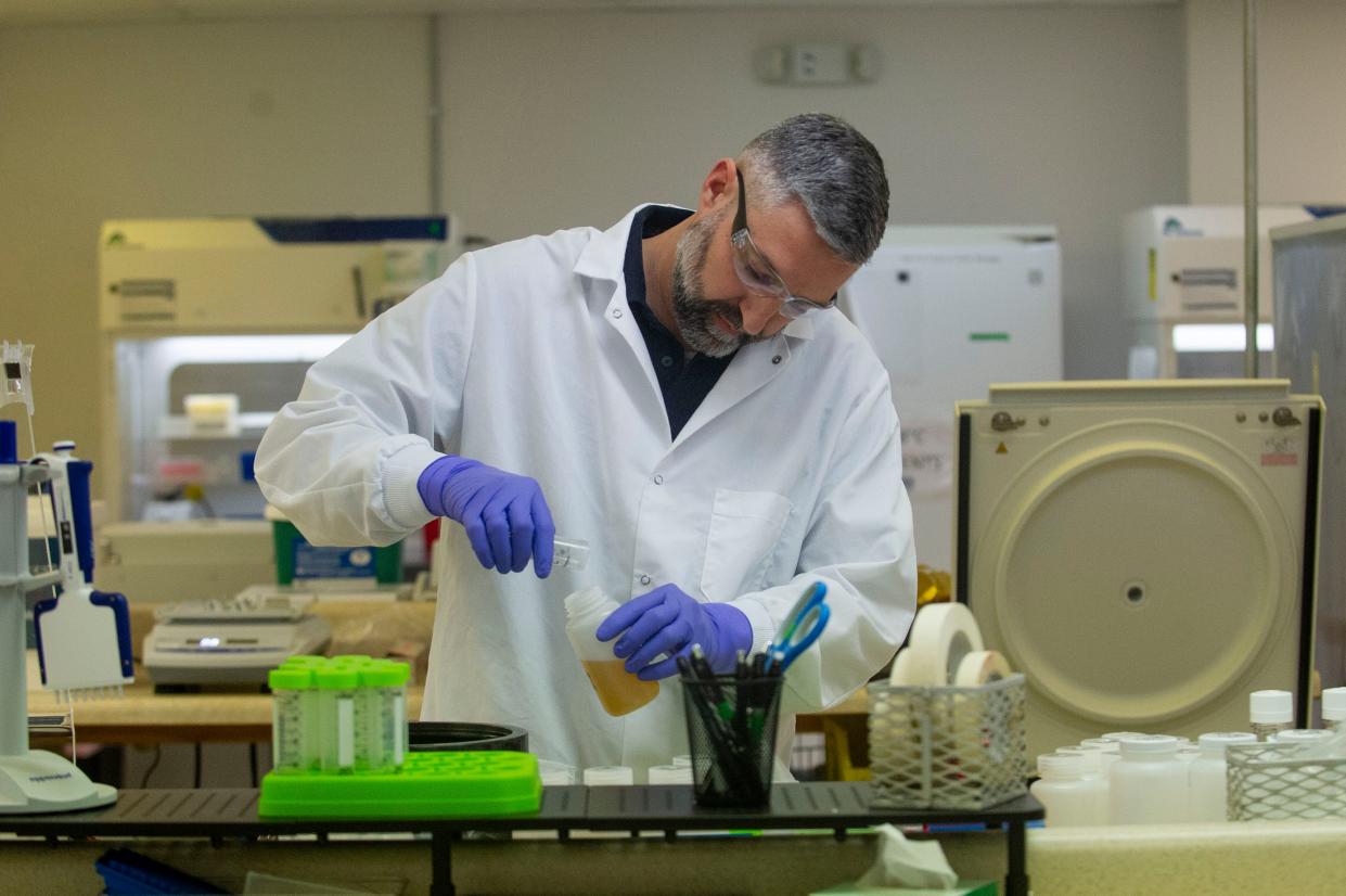 Jason Liggett, chief scientific officer, prepares reagents in the lab at New Day Diagnostics in Knoxville. New Day's colorectal cancer blood test is available for Knoxville residents and is pending FDA approval.