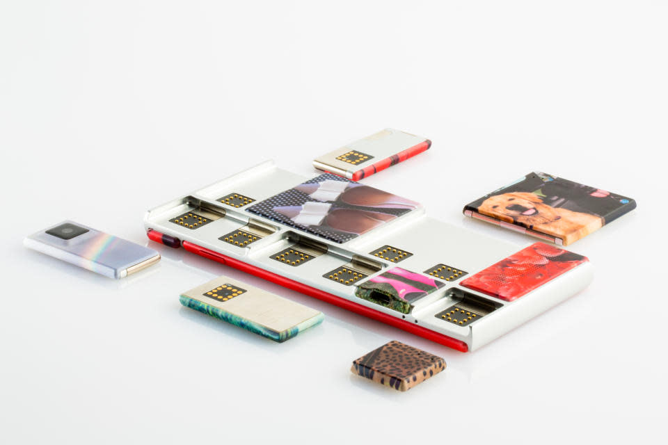 Photo of a modular smartphone with various rectangular components scattered around.