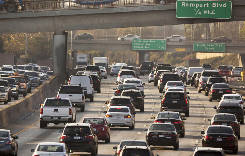 FILE - In this Dec. 12, 2018, file photo, traffic moves along the Hollywood Freeway in Los Angeles. At a board meeting Tuesday, Dec. 1, 2020, the Alliance for Automotive Innovation, a big industry trade association, recognized that change is coming. Alliance CEO John Bozzella said automakers are committed to working with the Biden administration, which will renew the fight against climate change and likely will undo pollution and gas mileage rollbacks made by President Donald Trump. (AP Photo/Damian Dovarganes, File)