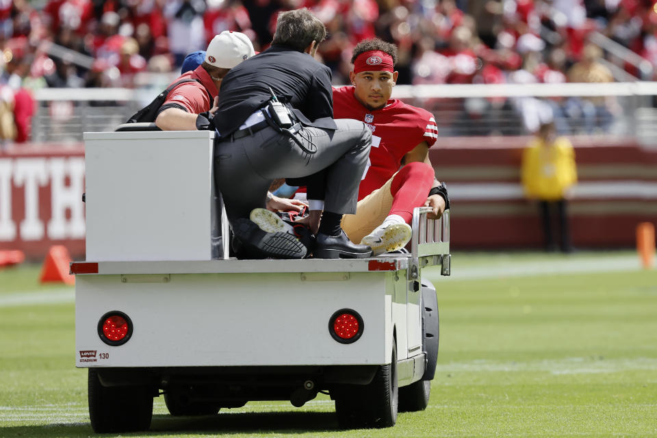 San Francisco 49ers quarterback Trey Lance, right, is carted off the field during the first half of an NFL football game against the Seattle Seahawks in Santa Clara, Calif., Sunday, Sept. 18, 2022. (AP Photo/Josie Lepe)