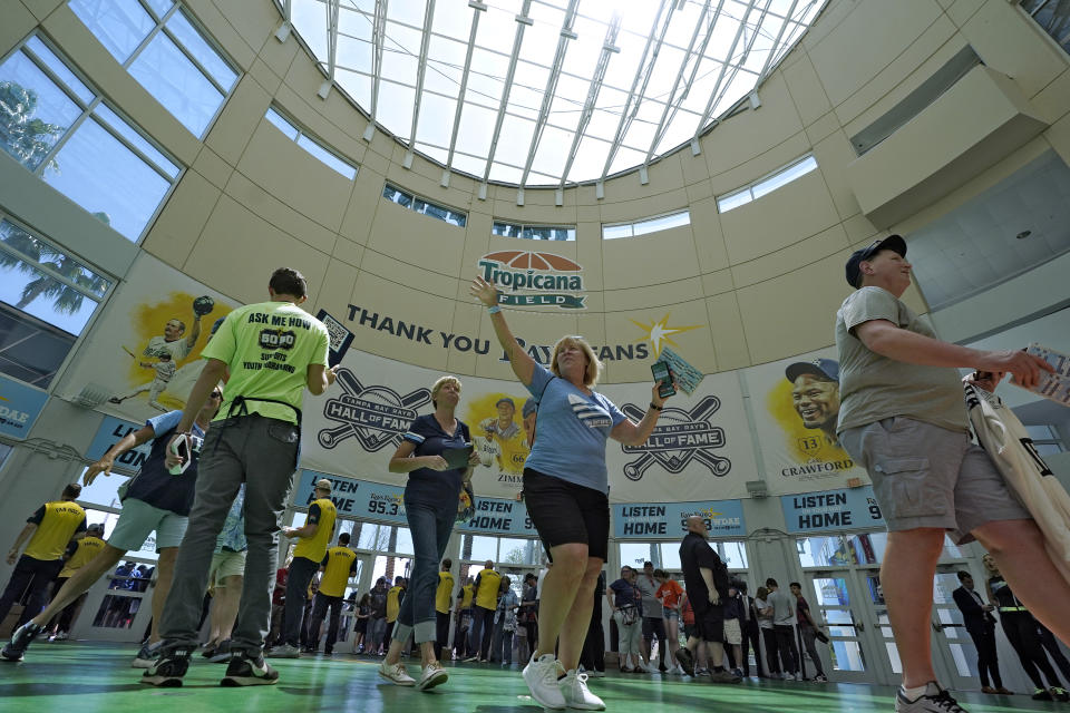 Fans arrive at Tropicana Field before an opening day baseball game between the Tampa Bay Rays and the Detroit Tigers Thursday, March 30, 2023, in St. Petersburg, Fla. (AP Photo/Chris O'Meara)