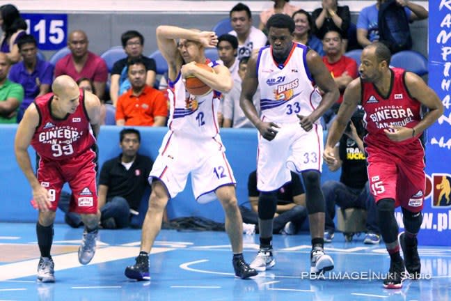 Air21's Mark Isip winces as he holds on to the ball in the Ari21-Ginebra game last Feb. 10 at the Smart Araneta Coliseum. (Nuki Sabio/PBA Images)