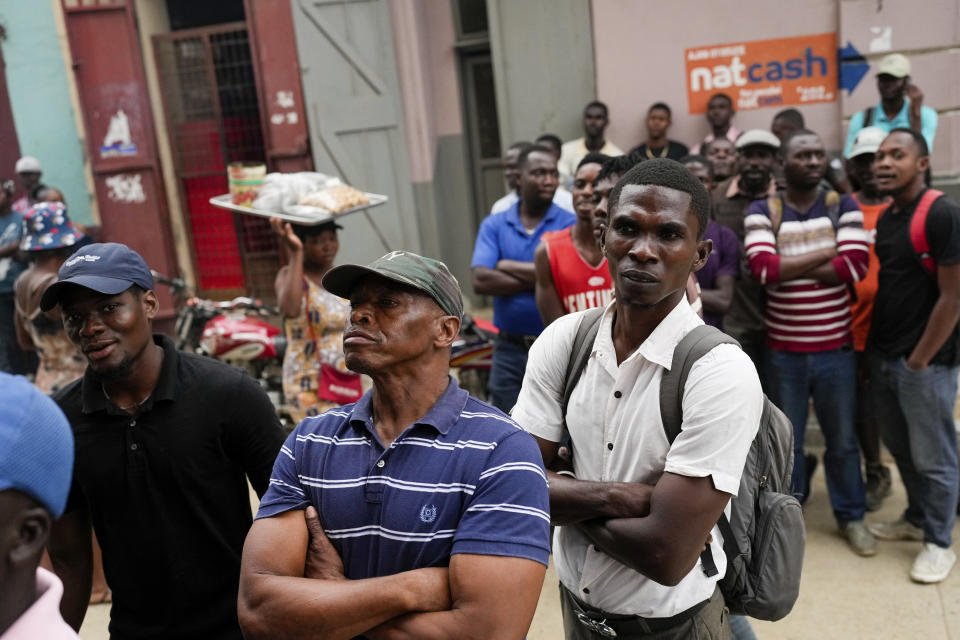 Men watch a soccer match televised in a shop in Cap-Haitien, Haiti, Wednesday, April 17, 2024. (AP Photo/Ramon Espinosa)