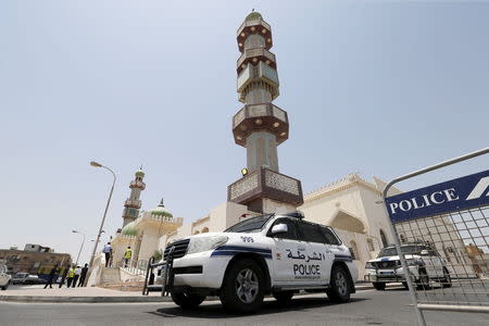 Police vehicles are parked outside the Al A'ali Grand Mosque where joint Sunni and Shi'ites prayers are to be held to show solidarity and co-existence between the two sects of Islam, ahead of Friday prayers in Al A'ali south of Manama, July 3, 2015. REUTERS/Hamad I Mohammed