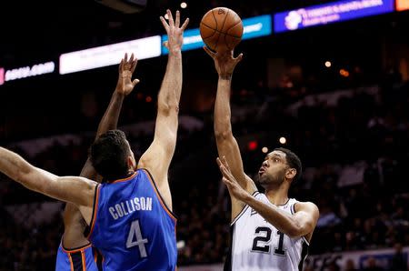 May 19, 2014; San Antonio, TX, USA; San Antonio Spurs forward Tim Duncan (21) shoots the ball over Oklahoma City Thunder forward Nick Collison (4) and center Kendrick Perkins (behind) in game one of the Western Conference Finals in the 2014 NBA Playoffs at AT&T Center. Soobum Im-USA TODAY Sports