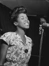 <p>Jazz singer Sarah Vaughan (aka “Sassy” or “The Divine One”) has been described as having one of “the most wondrous voices of the 20th century” <a href="http://www.allmusic.com/artist/sarah-vaughan-mn0000204901/biography" rel="nofollow noopener" target="_blank" data-ylk="slk:by music critic Scott Yanow;elm:context_link;itc:0;sec:content-canvas" class="link ">by music critic Scott Yanow</a> — and we won’t argue. <a href="https://www.youtube.com/watch?v=yJ-9IBZaydQ" rel="nofollow noopener" target="_blank" data-ylk="slk:In a now-iconic live recording made in Europe in 1964;elm:context_link;itc:0;sec:content-canvas" class="link ">In a now-iconic live recording made in Europe in 1964</a>, Vaughan took the stage nervously “with a cold,” but the moment she began singing the classic tune “Misty,” the audience was transcended into musical bliss. She was a class act — always immaculately made up and wearing in stylish, form-fitting dresses. <i>(Photo: Getty Images)</i></p>