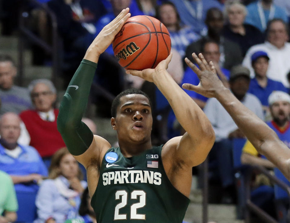 FILE - In this March 19, 2017, file photo, Michigan State guard Miles Bridges (22) attempts a three-point basket against Kansas in the first half of a second-round game in the men's NCAA college basketball tournament, in Tulsa, Okla. Michigan State freshman standout Miles Bridges is set to announce his highly anticipated decision to stay in school or enter the NBA Draft. Bridges posted a message on his Twitter account Thursday, April 13, that read: “Meet Me At Sparty tonight at 6 p.m. I’ve got something to say. It’s NOT about me, It’s about US.” (AP Photo/Tony Gutierrez, File)