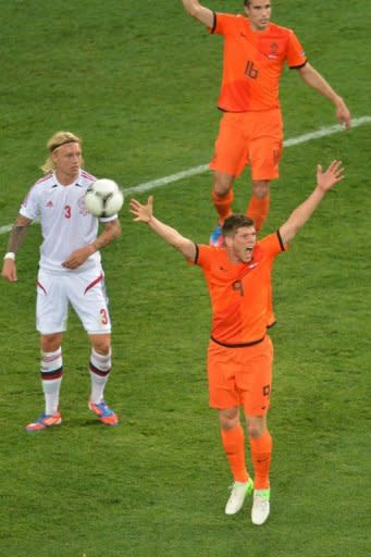 Dutch forward Klaas-Jan Huntelaar (R) gestures next to Danish defender Simon KjÃ¦r during their Euro 2012 football match