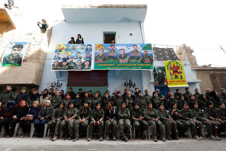 Kurdish female fighters of the Women's Protection Unit (YPJ) hold their weapons as they sit in the Sheikh Maksoud neighbourhood of Aleppo, Syria February 7, 2018. Picture taken February 7, 2018. REUTERS/Omar Sanadiki