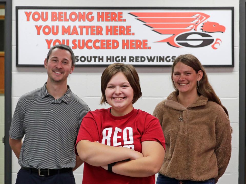 Sheboygan South student Cheyenne Stirdivant, 17, center, is taking on the responsibility planning of an emergency personnel fun event. She poses, Friday, Nov. 3, 2023, with South Dean of Students Ben Steen, left, and her mom, Lacey.