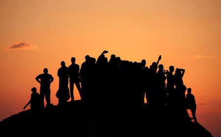 Palestinian demonstrators gather atop a hill during a protest calling for lifting the Israeli blockade on Gaza, near the maritime border with Israel, in the northern Gaza Strip September 17, 2018. REUTERS/Mohammed Salem