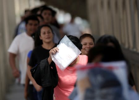 Mexican migrants deported from the U.S. walk towards Mexico at Paso del Norte International border bridge, in this picture taken from Ciudad Juarez