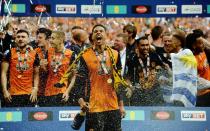 Britain Soccer Football - Hull City v Sheffield Wednesday - Sky Bet Football League Championship Play-Off Final - Wembley Stadium - 28/5/16 Hull City's Curtis Davies is sprayed with champagne as he celebrates winning promotion back to the Premier League Action Images via Reuters / Andrew Couldridge Livepic EDITORIAL USE ONLY. No use with unauthorized audio, video, data, fixture lists, club/league logos or "live" services. Online in-match use limited to 45 images, no video emulation. No use in betting, games or single club/league/player publications. Please contact your account representative for further details.