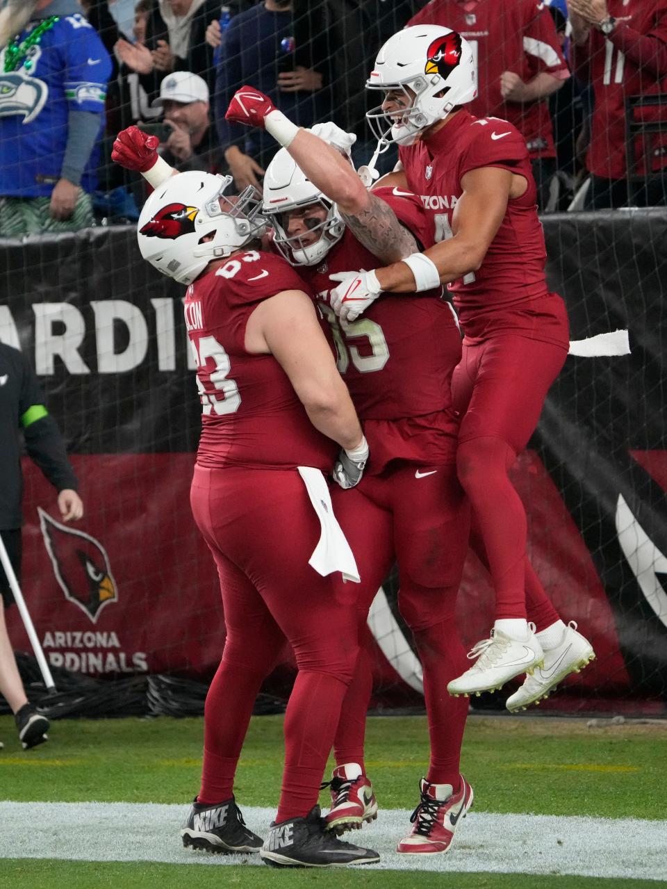 Arizona Cardinals tight end Trey McBride (85) celebrates his touchdown catch with center Trystan Colon (63) and wide receiver Michael Wilson (14) against the Seattle Seahawks during the fourth quarter in Glendale on Jan. 7, 2024.