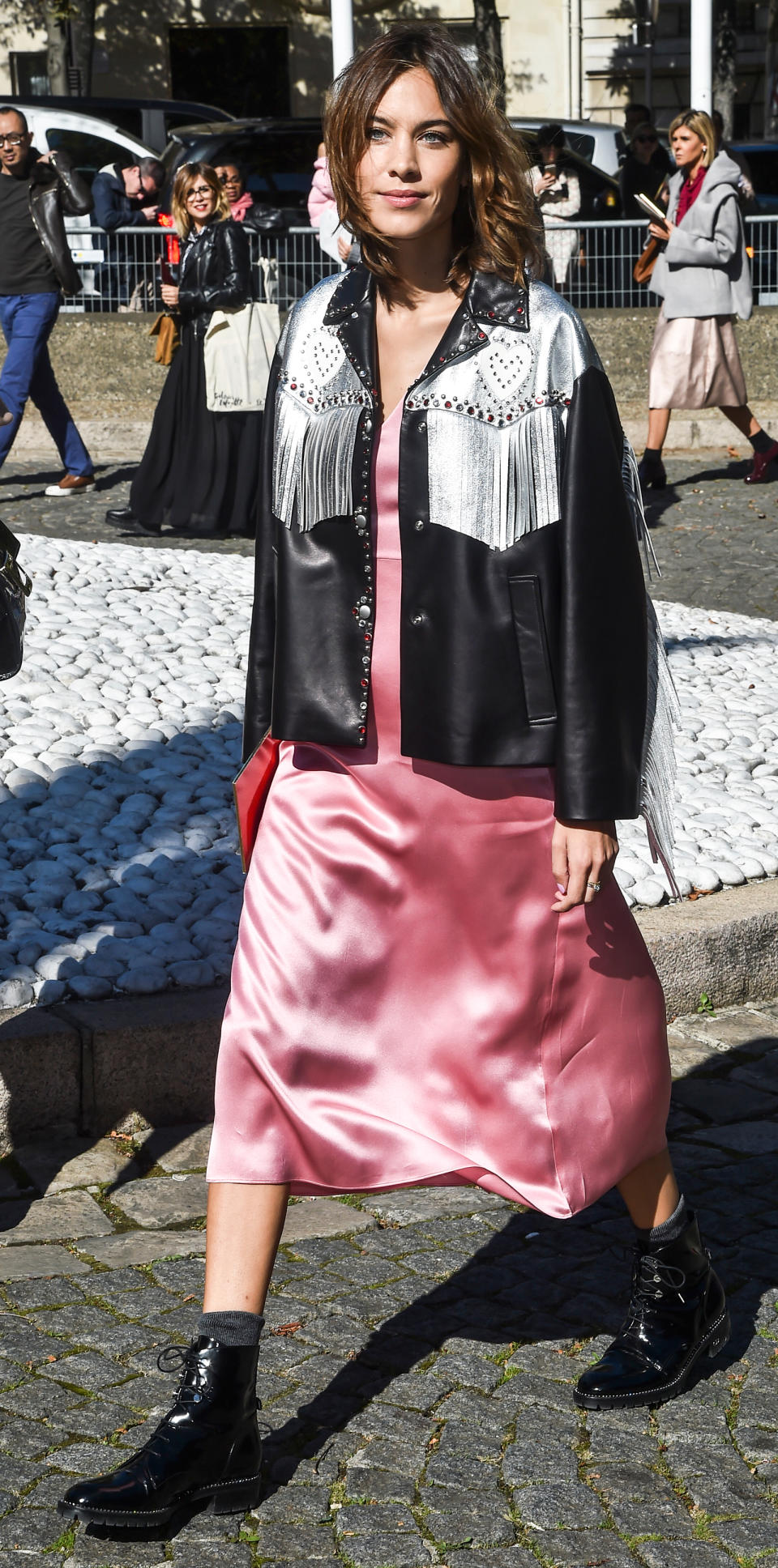 <p>Chung balanced out her Western-style leather jacket and black combat boots with a feminine pink slip dress (get a similar style <a rel="nofollow noopener" href="https://click.linksynergy.com/fs-bin/click?id=93xLBvPhAeE&subid=0&offerid=460292.1&type=10&tmpid=20905&RD_PARM1=http%3A%2F%2Fwww.asos.com%2Fneon-rose%2Fneon-rose-v-neck-slip-dress-with-wide-tie-shoulders-in-satin%2Fprd%2F7640438&u1=ISAlexaChungStreetStyle3.22JA" target="_blank" data-ylk="slk:here;elm:context_link;itc:0;sec:content-canvas" class="link ">here</a>) while at Paris Fashion Week. </p>