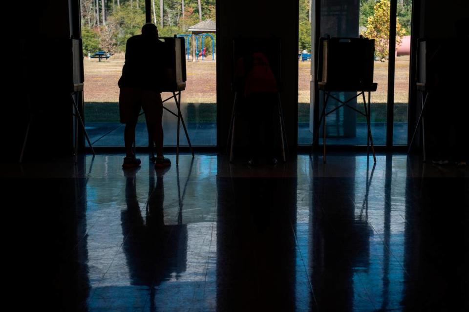 A voter casts a ballot at Orange Grove Community Center in Harrison County Tuesday. The election is for state and county offices.