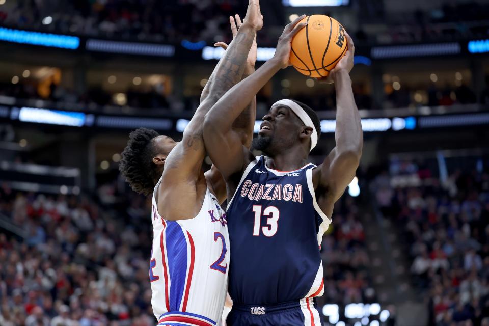 Mar 23, 2024; Salt Lake City, UT, USA; Gonzaga Bulldogs forward Graham Ike (13) shoots against Kansas Jayhawks forward K.J. Adams Jr. (24) during the first half in the second round of the 2024 NCAA Tournament at Vivint Smart Home Arena-Delta Center. Mandatory Credit: Rob Gray-USA TODAY Sports